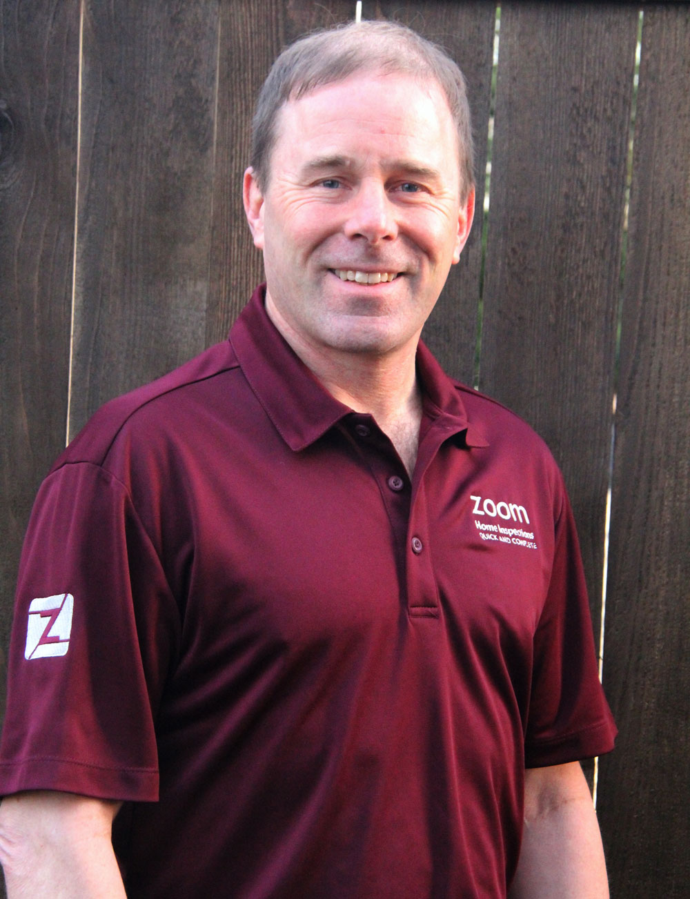 A picture of Brian wearing a shirt that says Zoom Home Inspections. Brian is the owner of Zoom Home Inspections.