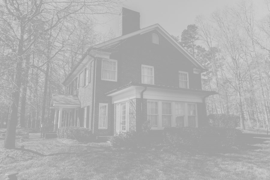 An old house framed by winter trees.