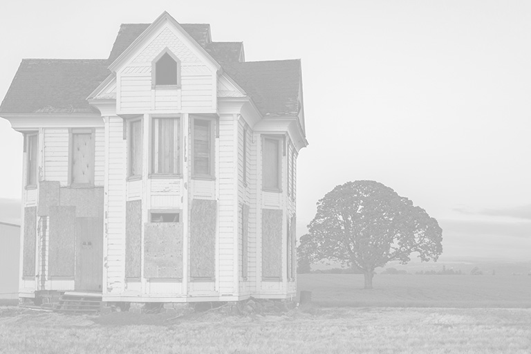 fixer-upper house with boarded up windows